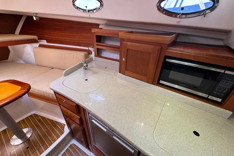 Mary Time Yacht Photos Pics 2013 Back Cove 30 yacht interior with kitchenette, microwave, and seating area.