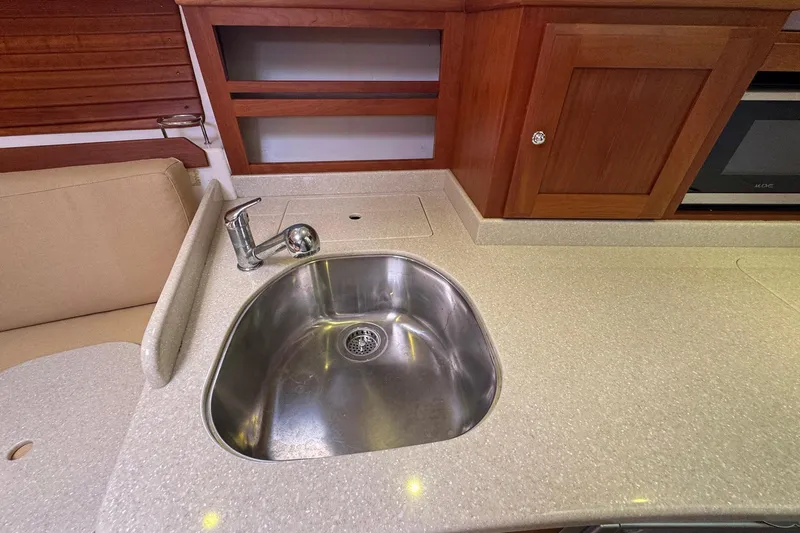 Mary Time Yacht Photos Pics 2013 Back Cove 30 yacht kitchen with stainless steel sink and wooden cabinetry.
