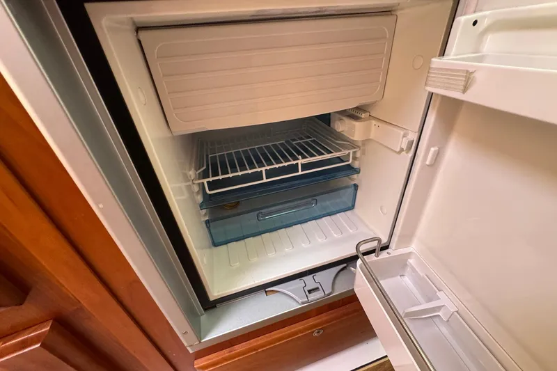 Mary Time Yacht Photos Pics Open refrigerator inside a 2013 Back Cove 30 boat, featuring shelves and storage compartments.