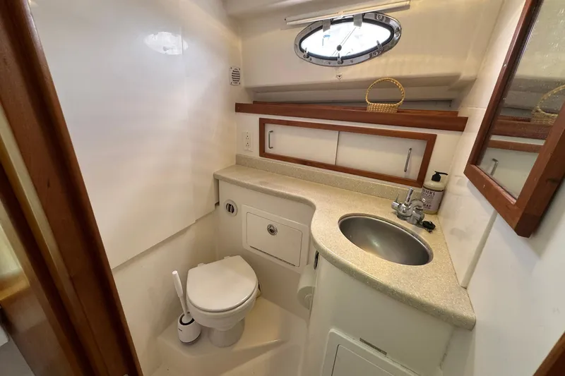 Mary Time Yacht Photos Pics 2013 Back Cove 30 yacht bathroom with sink, toilet, and porthole window.