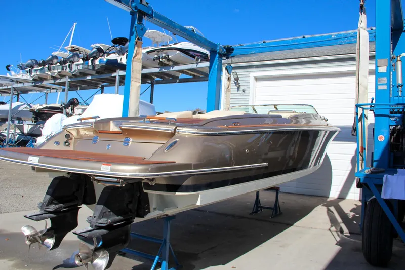  Yacht Photos Pics 2013 Chris-Craft Launch 32 boat on lift, showcasing sleek design and dual engines.