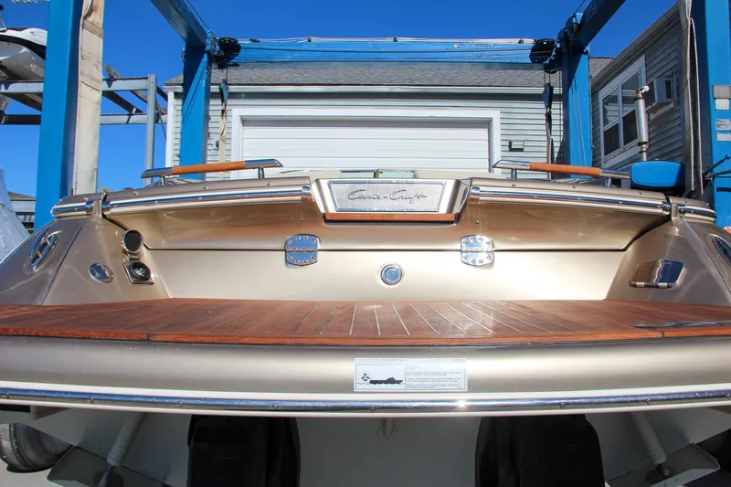  Yacht Photos Pics 2013 Chris-Craft Launch 32 boat stern view with wooden deck and metallic finish.