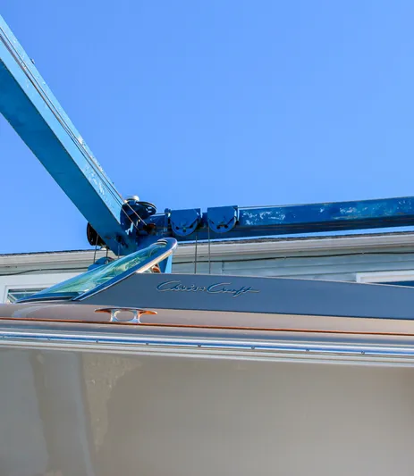  Yacht Photos Pics 2013 Chris-Craft Launch 32 boat under blue crane against clear sky.