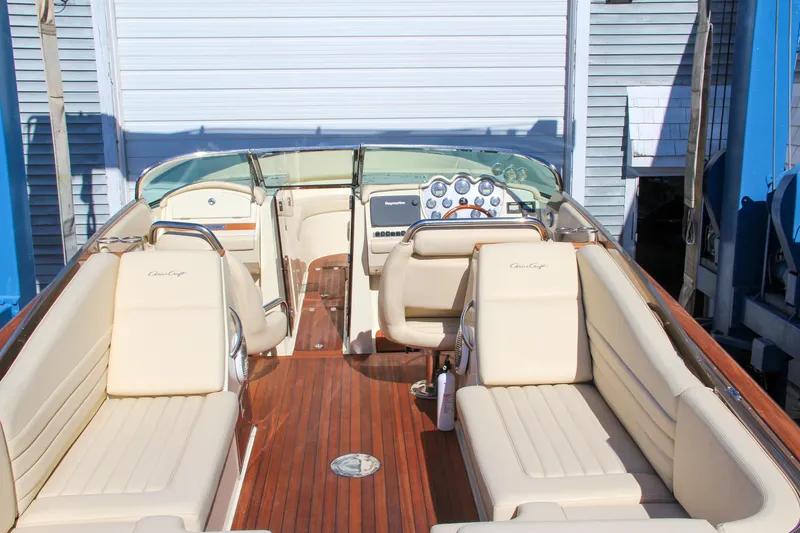  Yacht Photos Pics 2013 Chris-Craft Launch 32 boat with luxurious beige seating and wooden deck.