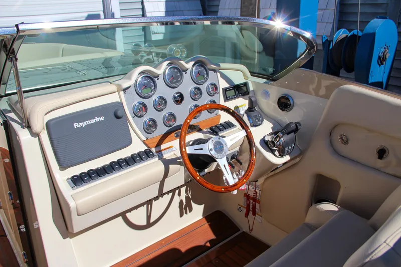  Yacht Photos Pics 2013 Chris-Craft Launch 32 dashboard with wood steering wheel and Raymarine electronics.