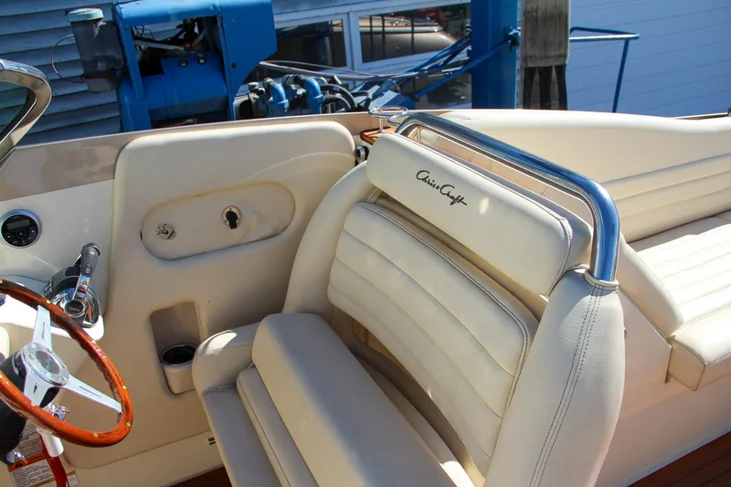  Yacht Photos Pics Luxurious interior of 2013 Chris-Craft Launch 32 boat with elegant seating and wooden steering wheel.
