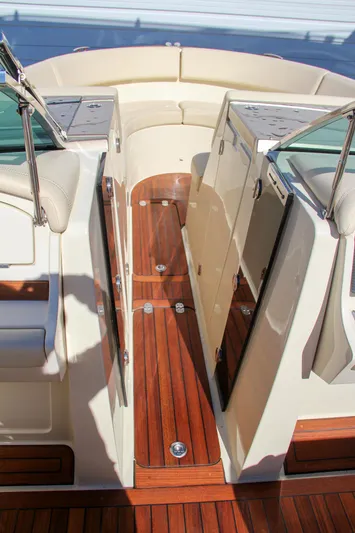  Yacht Photos Pics 2013 Chris-Craft Launch 32 boat interior with teak flooring and open seating area.