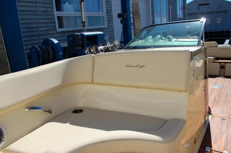  Yacht Photos Pics 2013 Chris-Craft Launch 32 boat interior with beige seating and wooden deck.