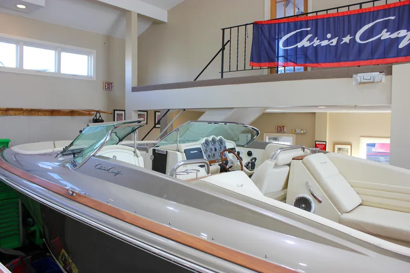  Yacht Photos Pics 2013 Chris-Craft Launch 32 boat displayed indoors, showcasing elegant design and luxurious seating.