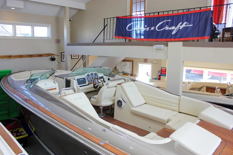  Yacht Photos Pics 2013 Chris-Craft Launch 32 boat displayed indoors with elegant seating and dashboard.