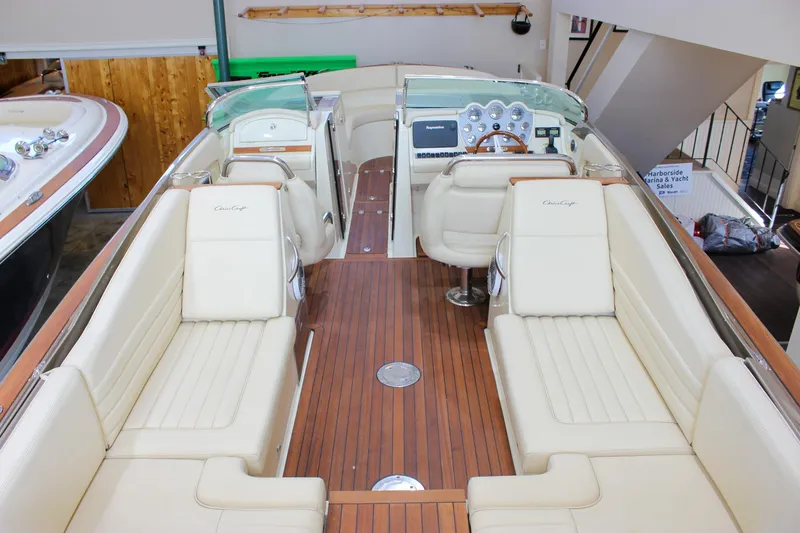  Yacht Photos Pics 2013 Chris-Craft Launch 32 boat interior with elegant seating and wooden flooring.