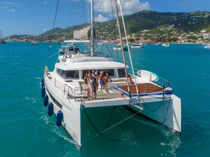  Yacht Photos Pics 2023 Bali 5.4 catamaran sailing in turquoise waters with people on deck.