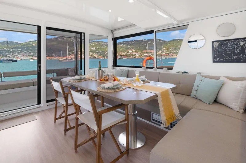  Yacht Photos Pics Modern interior of 2023 Bali 5.4 yacht with dining area and scenic ocean view.