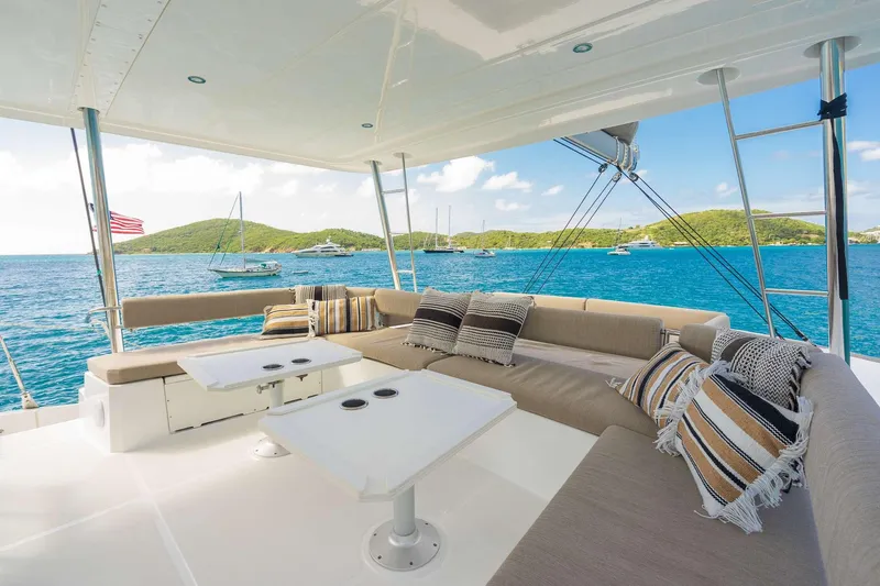  Yacht Photos Pics Luxurious Bali 5.4 yacht deck with seating, ocean view, and islands in the background, 2023 model.