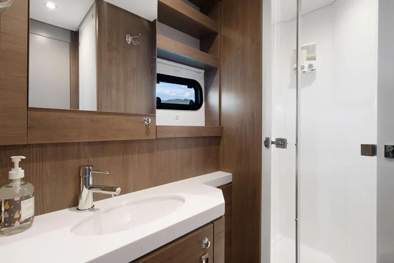  Yacht Photos Pics Modern bathroom interior in 2023 Bali 5.4 yacht, featuring wood accents and sleek fixtures.