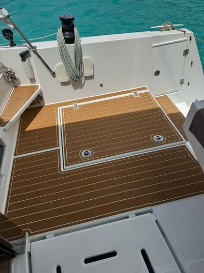  Yacht Photos Pics Bali 5.4 yacht deck, 2023 model, featuring teak flooring and turquoise water backdrop.