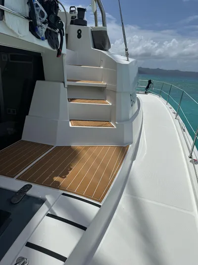  Yacht Photos Pics Modern Bali 5.4 yacht deck with wooden steps, 2023 model, sailing in clear turquoise waters.