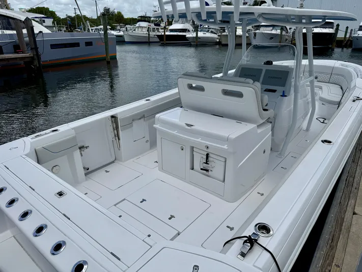  Yacht Photos Pics 2025 Intrepid 345 Nomad FE boat docked, featuring spacious deck and modern design.