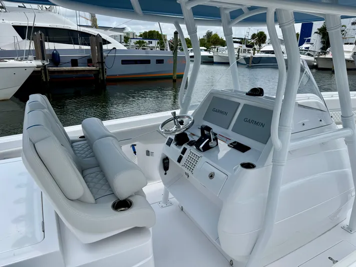  Yacht Photos Pics 2025 Intrepid 345 Nomad FE boat interior with dual Garmin displays at marina.