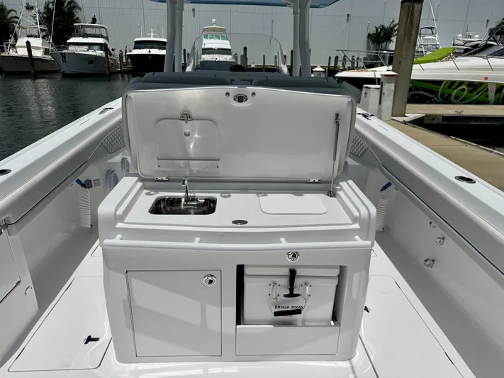  Yacht Photos Pics 2025 Intrepid 345 Nomad FE boat with onboard sink and storage at marina.