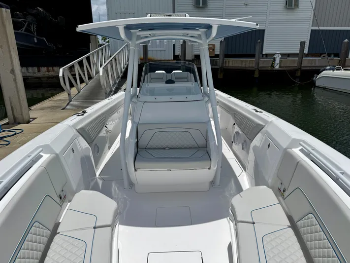  Yacht Photos Pics 2025 Intrepid 345 Nomad FE boat interior with white seating and modern design.