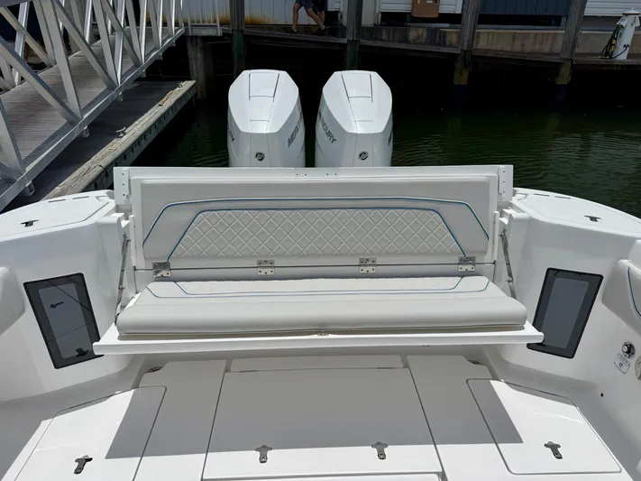  Yacht Photos Pics 2025 Intrepid 345 Nomad FE boat with dual Mercury engines and foldable rear seating.