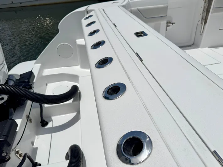  Yacht Photos Pics 2025 Intrepid 345 Nomad FE boat deck with rod holders and storage compartments.