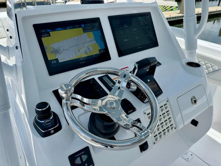  Yacht Photos Pics Intrepid 345 Nomad FE 2025 helm with dual displays and modern controls.