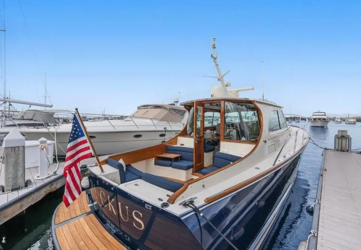 Ruckus Yacht Photos Pics 2009 Hinckley Talaria 44 MY yacht docked at marina, rear view with American flag.