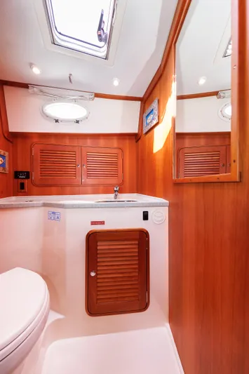 Ruckus Yacht Photos Pics 2009 Hinckley Talaria 44 MY yacht bathroom with wooden cabinetry and skylight.