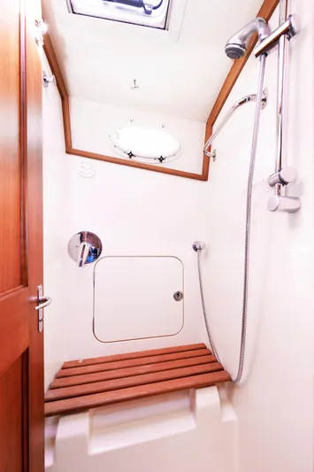 Ruckus Yacht Photos Pics 2009 Hinckley Talaria 44 MY yacht shower with wooden bench and modern fixtures.