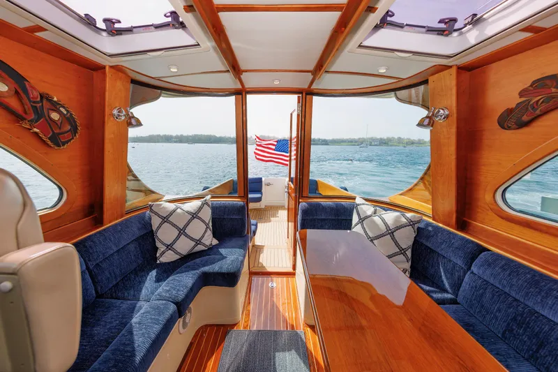 Ruckus Yacht Photos Pics Interior of 2009 Hinckley Talaria 44 MY yacht with blue seating and wooden accents.