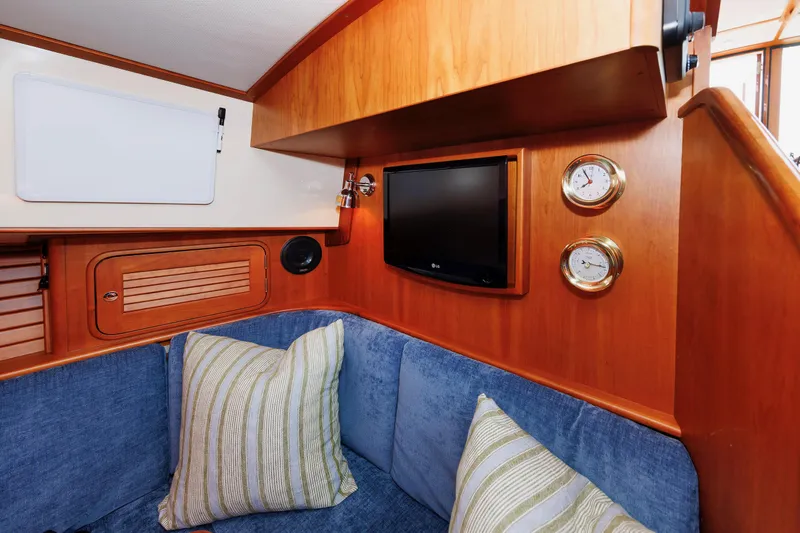 Ruckus Yacht Photos Pics Interior of 2009 Hinckley Talaria 44 MY with cozy seating, pillows, and wall-mounted gauges.