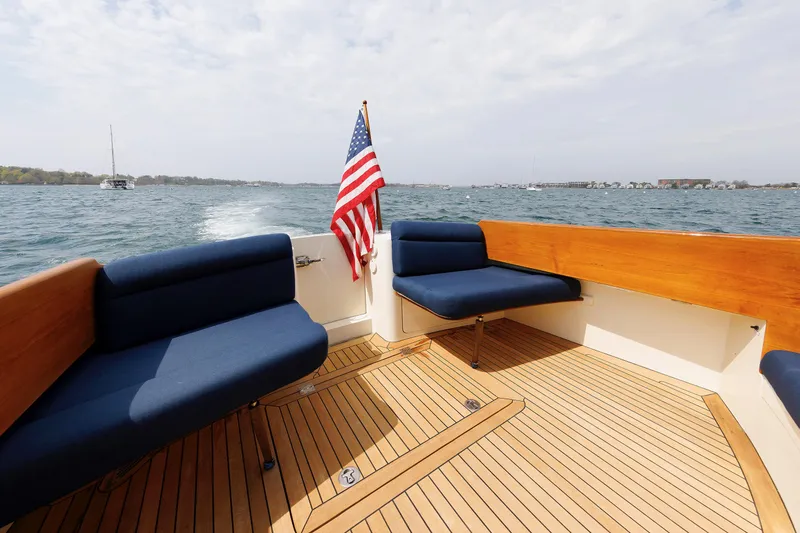 Ruckus Yacht Photos Pics Hinckley Talaria 44 MY 2009 boat deck with seating and American flag on open water.