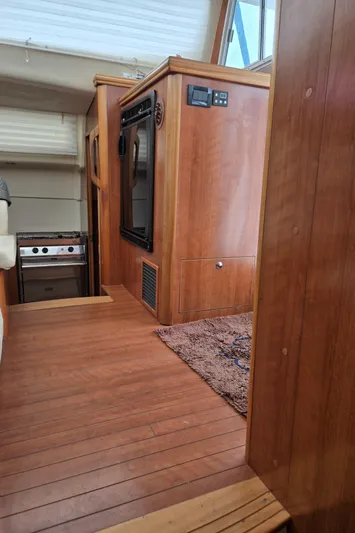 14hands Yacht Photos Pics Interior of 2013 Gemini Legacy 35 yacht with wood paneling and compact kitchen area.