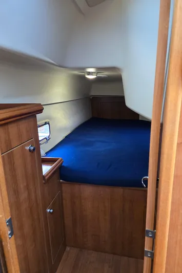 14hands Yacht Photos Pics Cozy cabin interior of 2013 Gemini Legacy 35 sailboat with blue bedding.