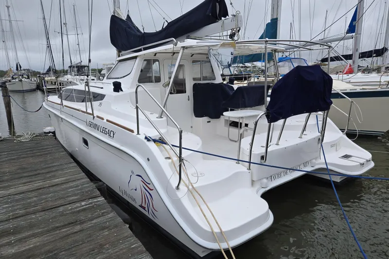 14hands Yacht Photos Pics 2013 Gemini Legacy 35 catamaran docked at a marina, featuring sleek design and spacious deck.