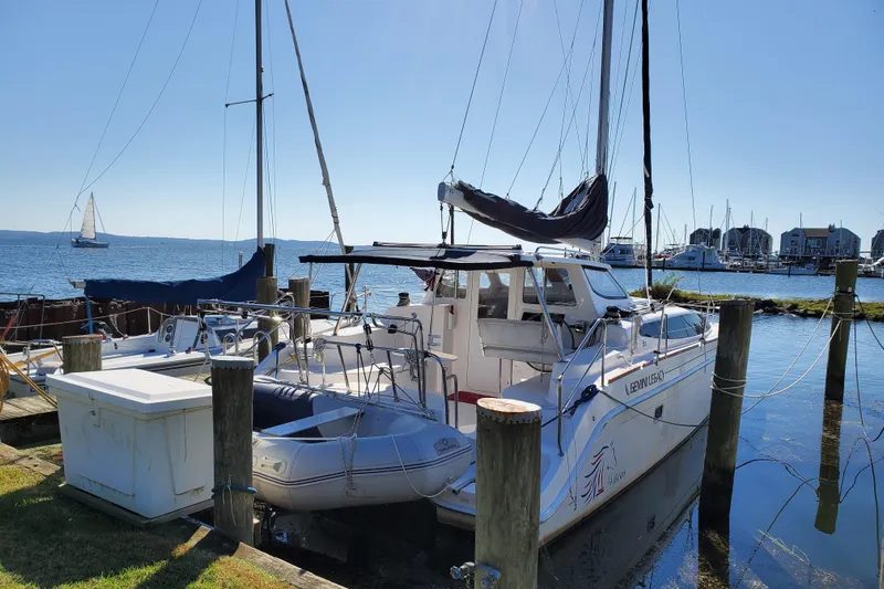 14hands Yacht Photos Pics 2013 Gemini Legacy 35 catamaran docked at a marina with sailboats in the background.