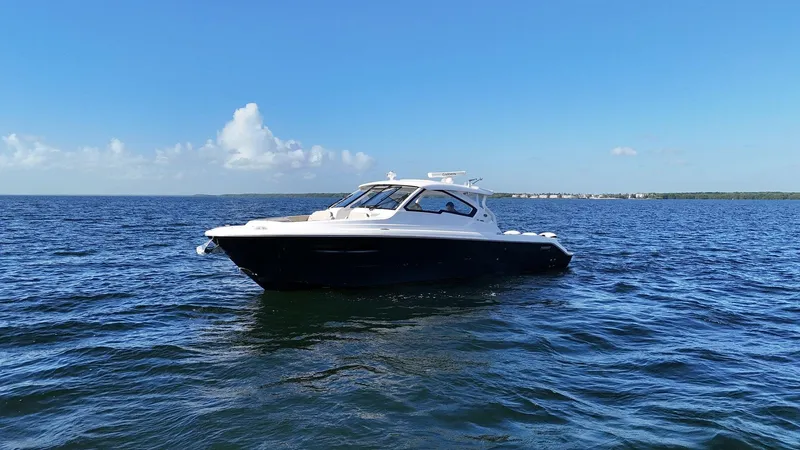 Lady B Yacht Photos Pics 2019 Pursuit 365 Dual Console boat on open water under clear blue sky.