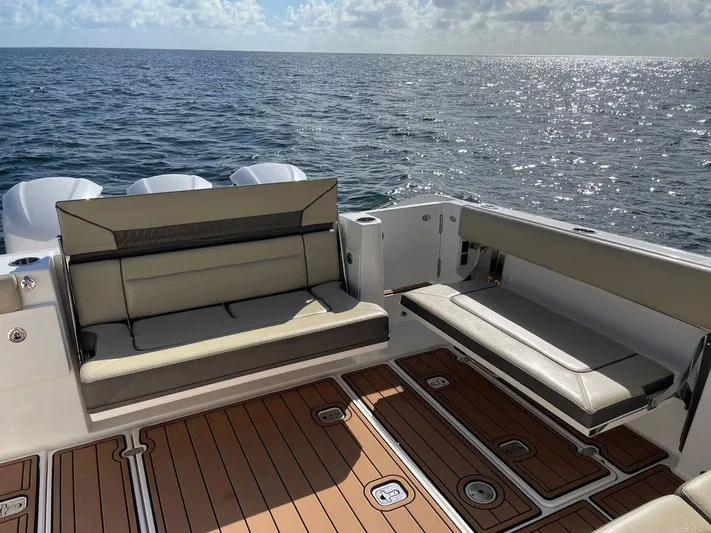 Lady B Yacht Photos Pics 2019 Pursuit 365 Dual Console boat interior with cushioned seating and ocean view.
