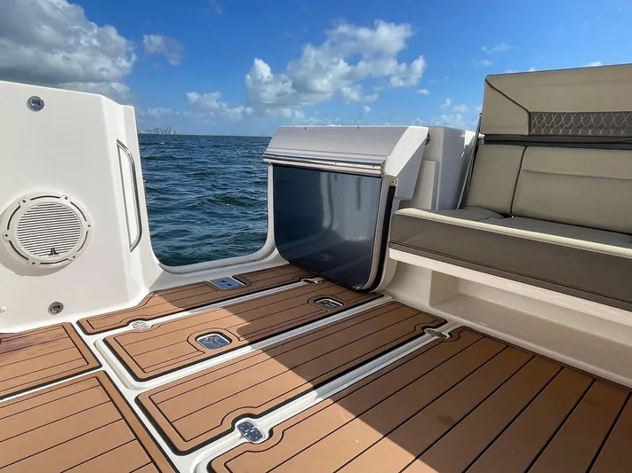 Lady B Yacht Photos Pics 2019 Pursuit 365 Dual Console boat interior with teak flooring and ocean view.