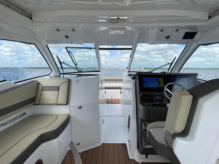 Lady B Yacht Photos Pics Interior view of a 2019 Pursuit 365 Dual Console boat with modern dashboard and seating.