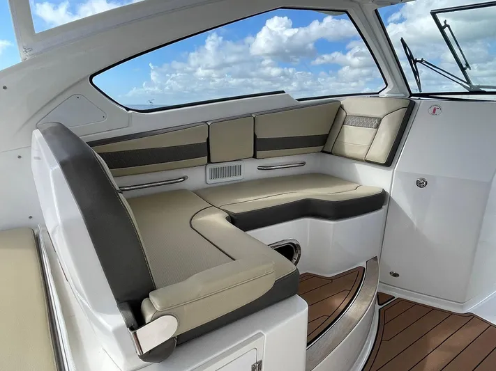 Lady B Yacht Photos Pics Luxurious interior of 2019 Pursuit 365 Dual Console boat with plush seating and wood flooring.