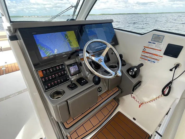 Lady B Yacht Photos Pics 2019 Pursuit 365 Dual Console boat cockpit with navigation screens and steering wheel.