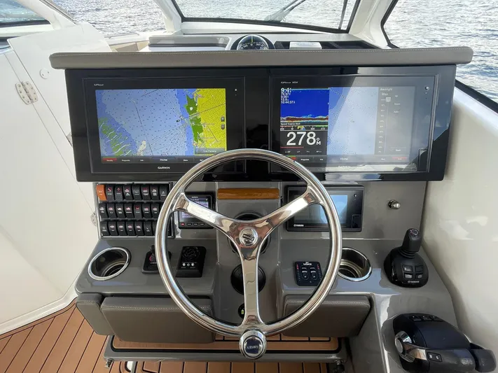 Lady B Yacht Photos Pics 2019 Pursuit 365 Dual Console boat dashboard with navigation screens and steering wheel.