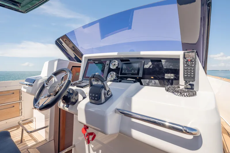 Tramonto Yacht Photos Pics Helm of 2021 Fjord 40 Open yacht with modern navigation equipment and steering wheel.