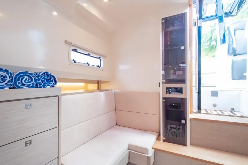 Tramonto Yacht Photos Pics Interior of 2021 Fjord 40 Open yacht, featuring modern seating and control panel.