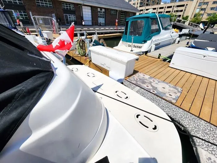  Yacht Photos Pics 1999 Sea Ray 460 Sundancer docked with Canadian flag, marina setting.