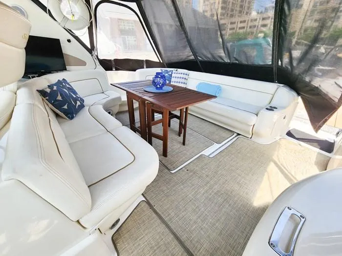  Yacht Photos Pics Luxurious interior of 1999 Sea Ray 460 Sundancer yacht with elegant seating and wooden table.