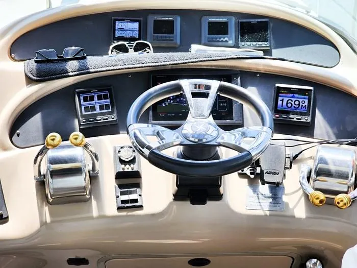  Yacht Photos Pics 1999 Sea Ray 460 Sundancer helm with steering wheel, gauges, and controls.